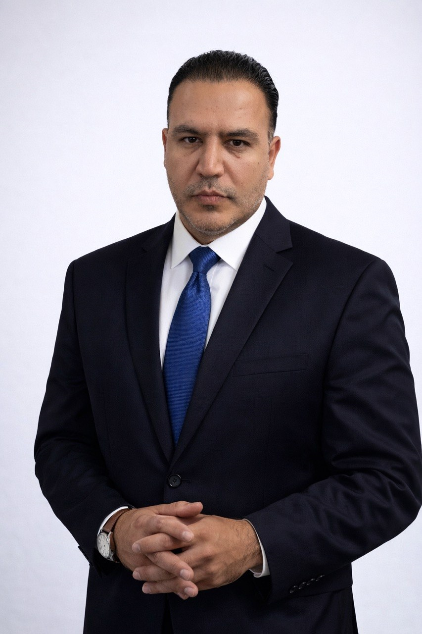 Milad Javadi in a navy suit and blue tie
